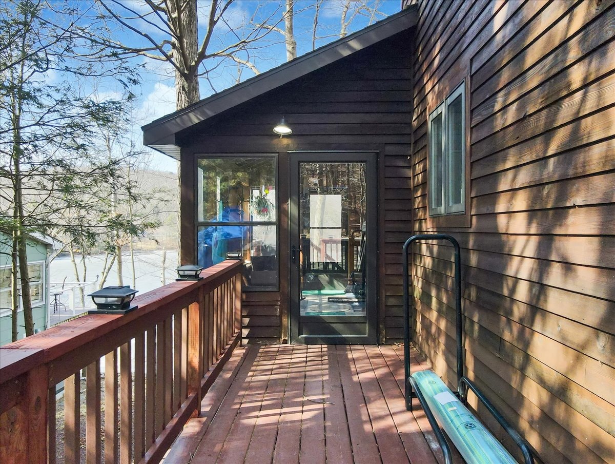 Side deck entry with French doors and lake view bench