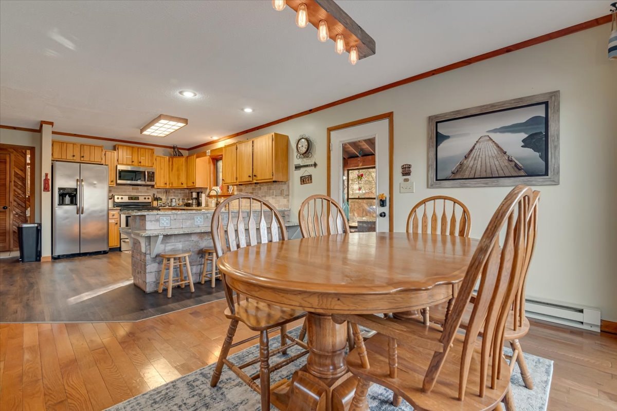 Kitchen and dining area with pine cabinets and granite island