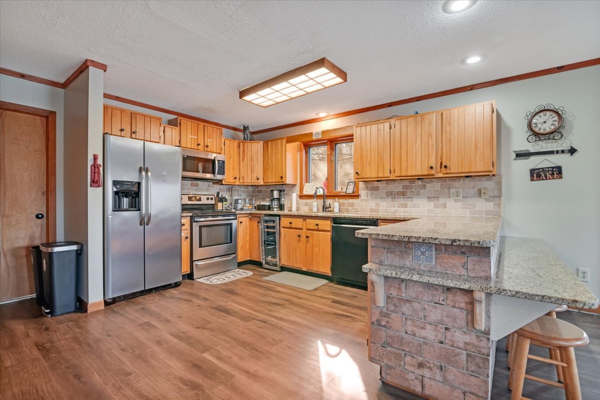Full kitchen with pine cabinets, stainless appliances and granite counters