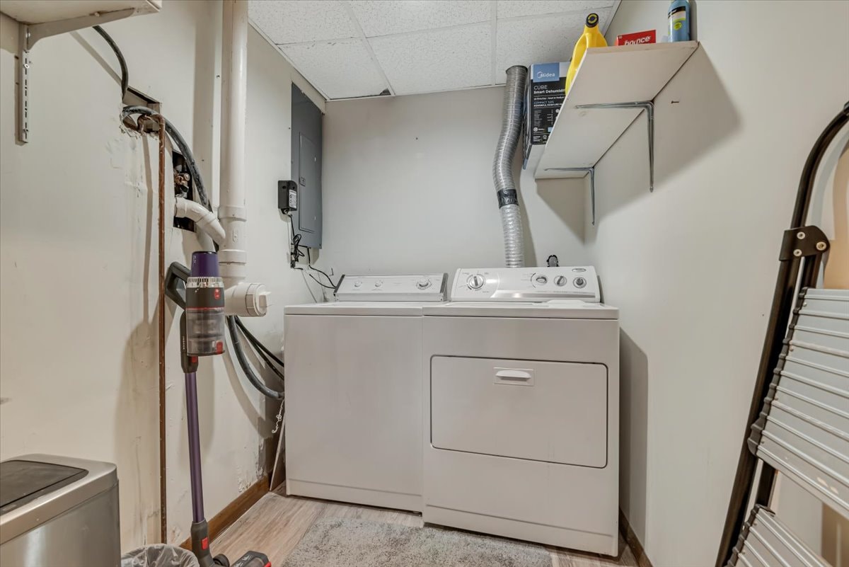 Basement laundry room with washer and dryer