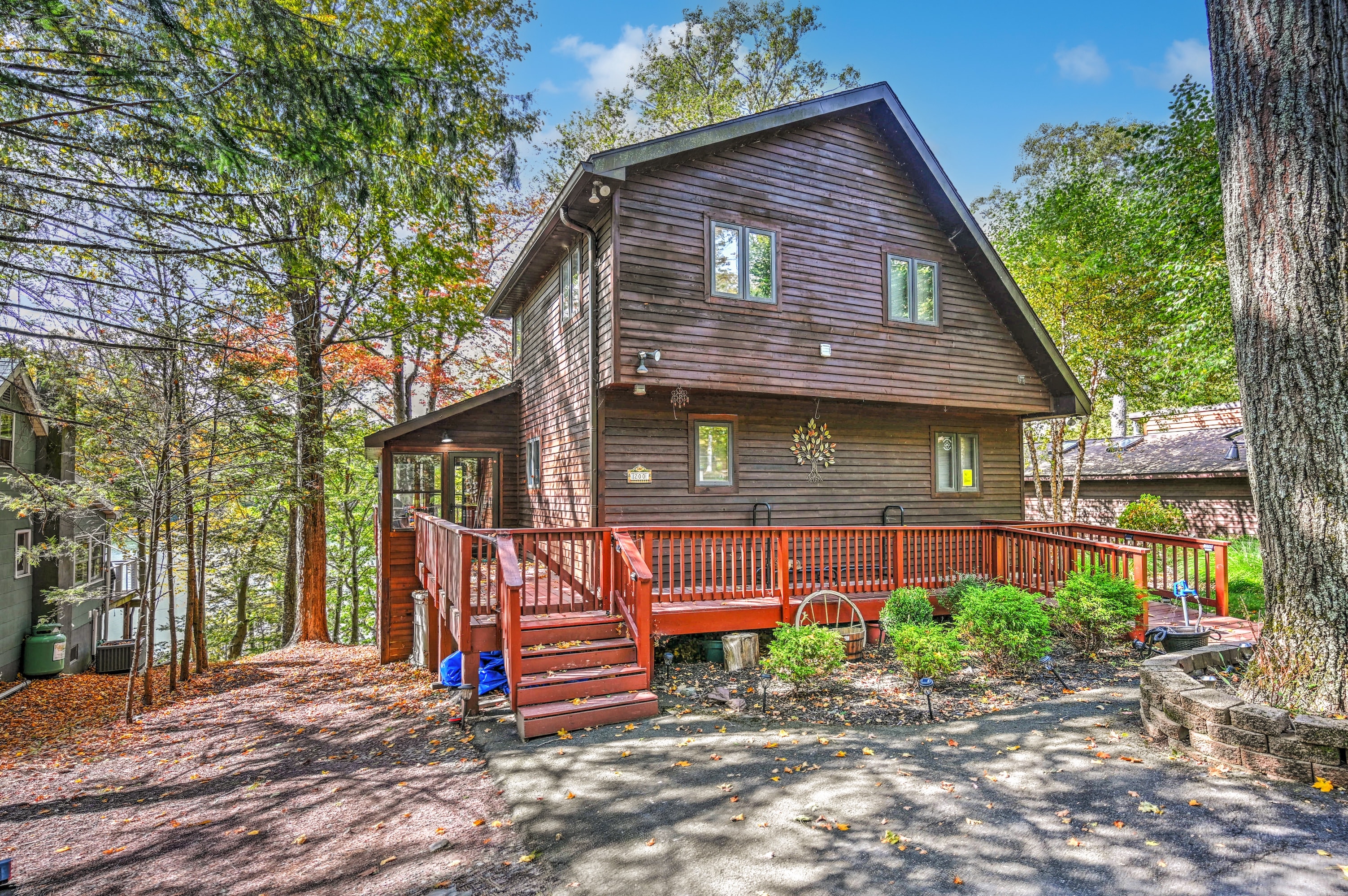 Kelly's Cove cabin exterior with red deck and autumn foliage