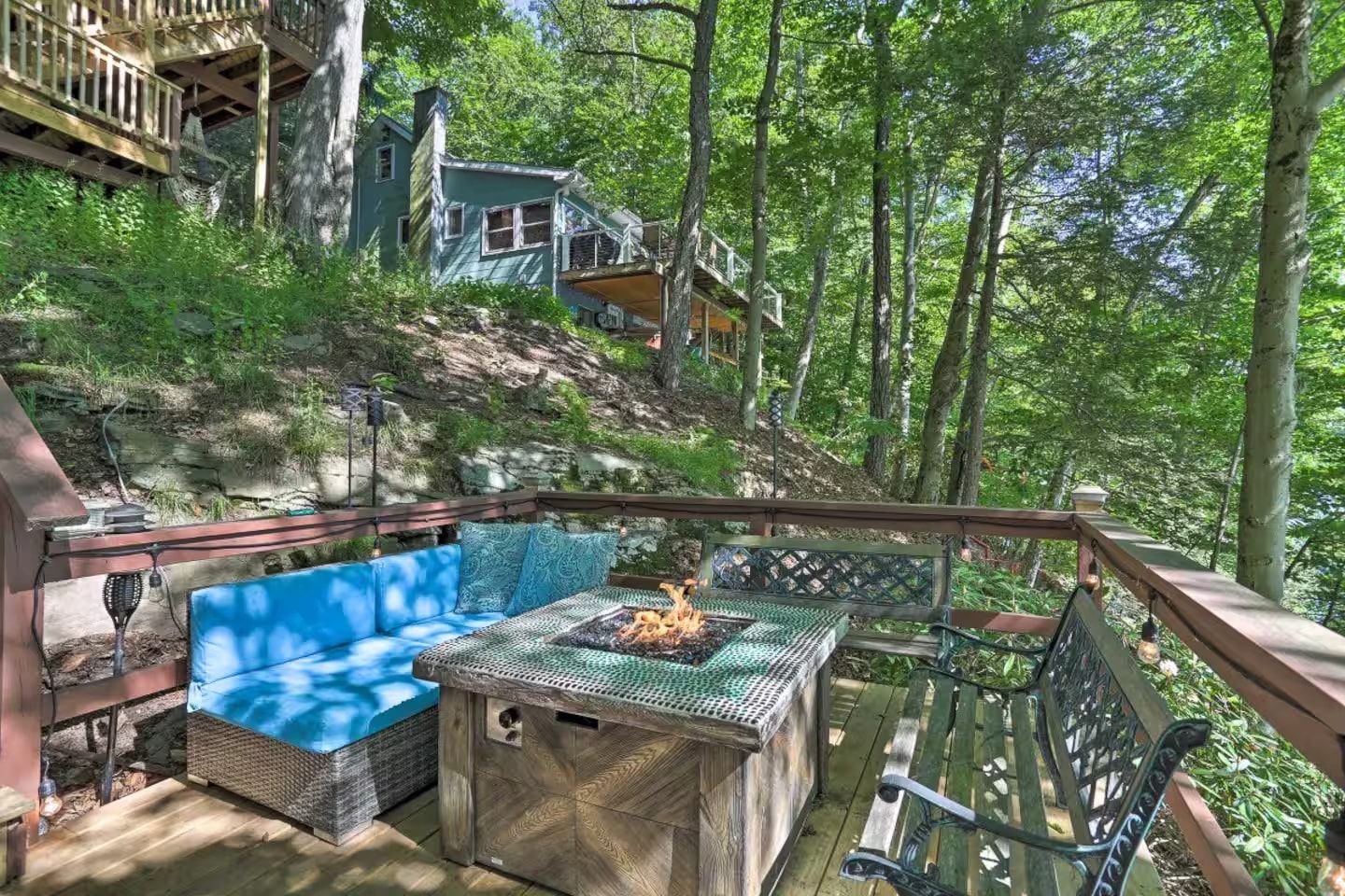 Lower landing deck with fire pit table and blue cushion seating